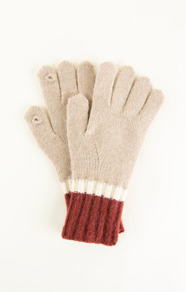 Pair of gloves with beige body and red cuffs on a white background