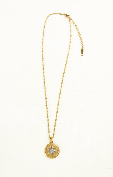 Gold necklace with a pendant on a white background