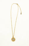 Gold necklace with a pendant on a white background