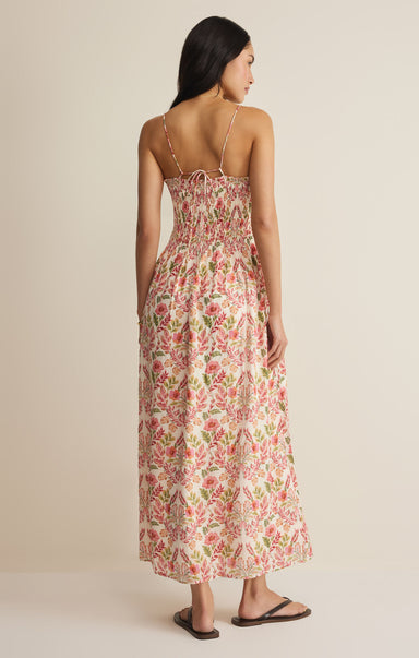 Woman wearing a floral dress against a beige background