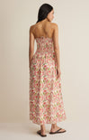 Woman wearing a floral dress against a beige background