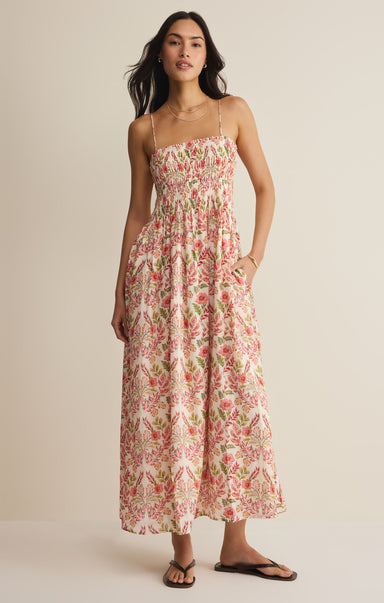 Woman wearing a floral dress against a beige background