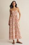 Woman wearing a floral dress against a beige background