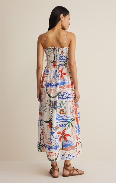 Woman wearing a colorful patterned dress on a beige background