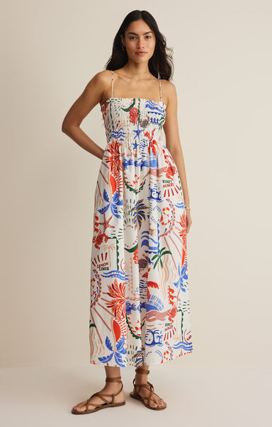 Woman wearing a colorful floral dress on a beige background