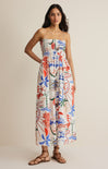 Woman wearing a colorful floral dress on a beige background