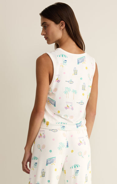 Woman wearing a sleeveless top with colorful graphic design on a beige background