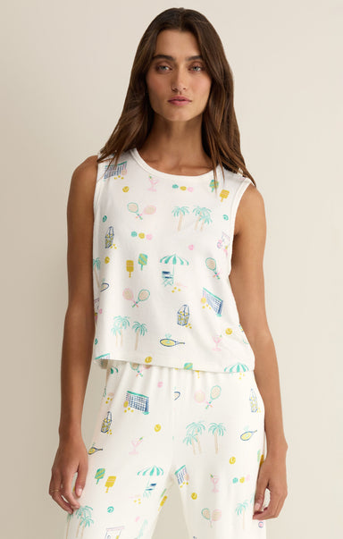 Woman wearing a white sleeveless top with colorful pattern on a beige background