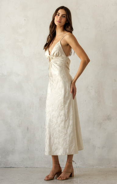 Woman wearing a white dress against a plain background