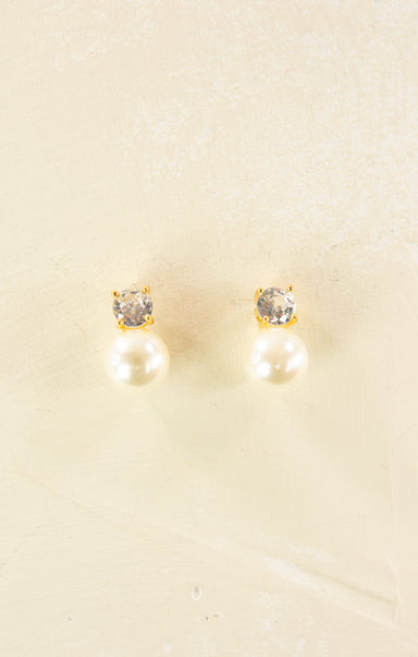 Pair of earrings with gemstones on a beige background