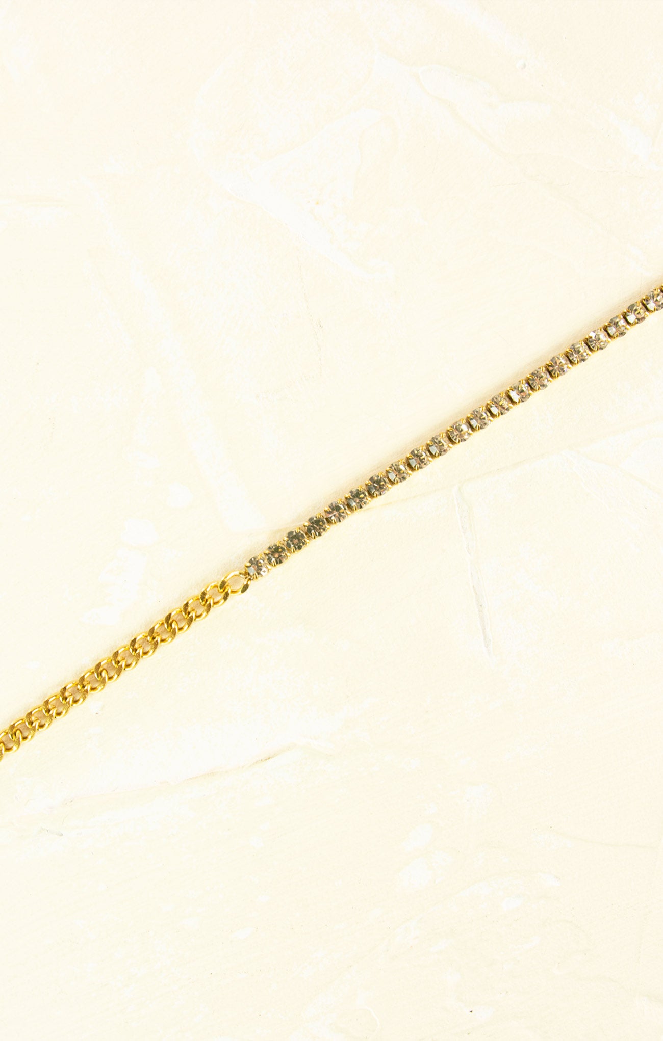 Gold chain on a light beige background