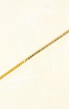 Gold chain on a light beige background