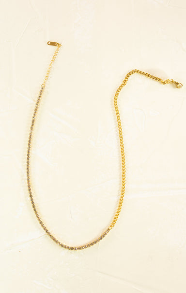 Gold necklace on a beige background