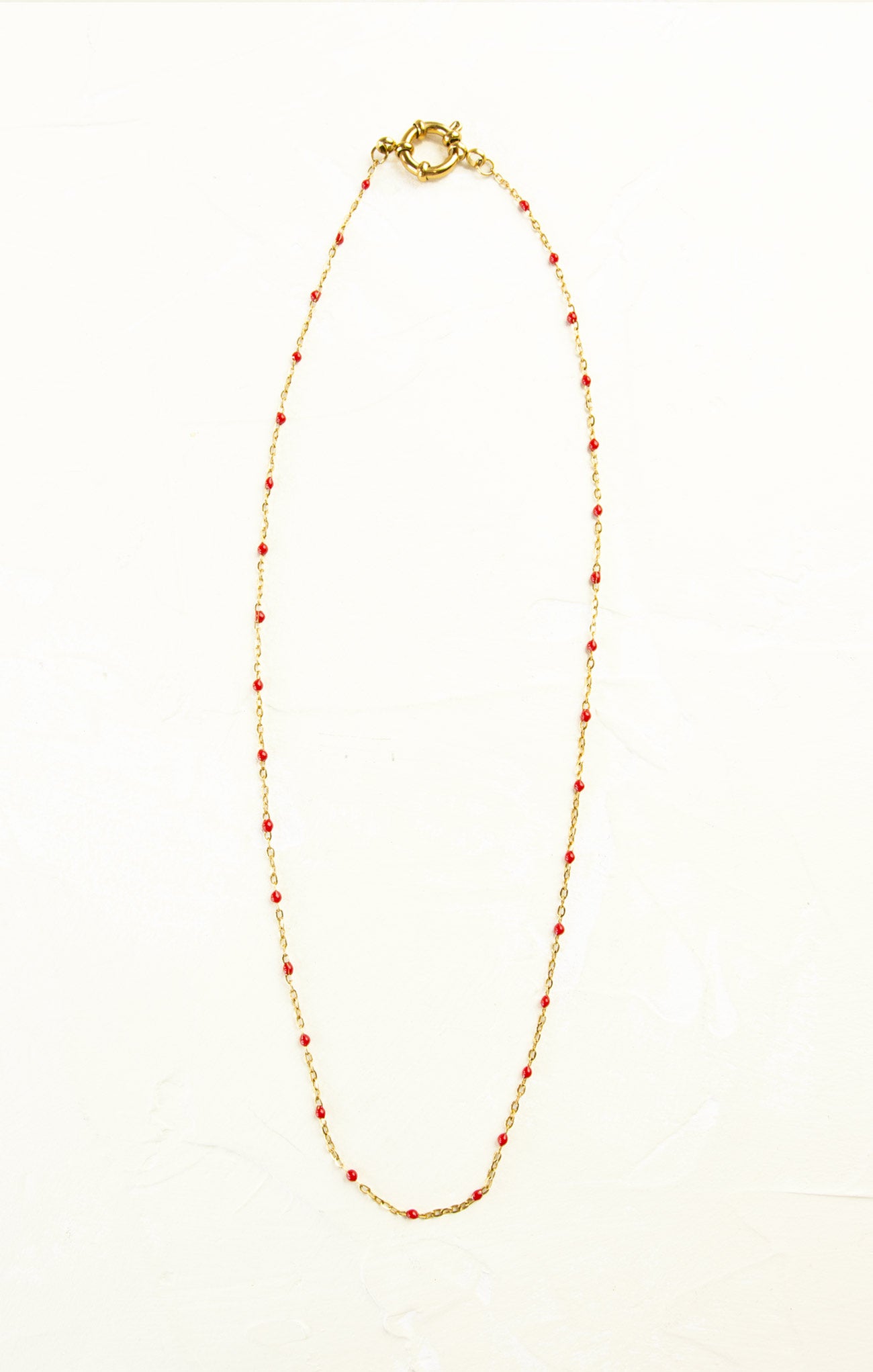 Necklace with red beads on a white background
