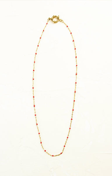 Necklace with red beads on a white background