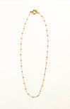Necklace with red beads on a white background