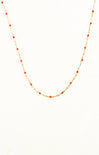 Necklace with red beads on a gold chain against a white background