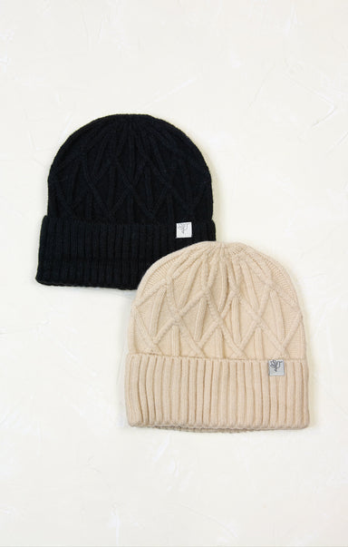 Two knit beanie hats, one black and one beige, on a white background.