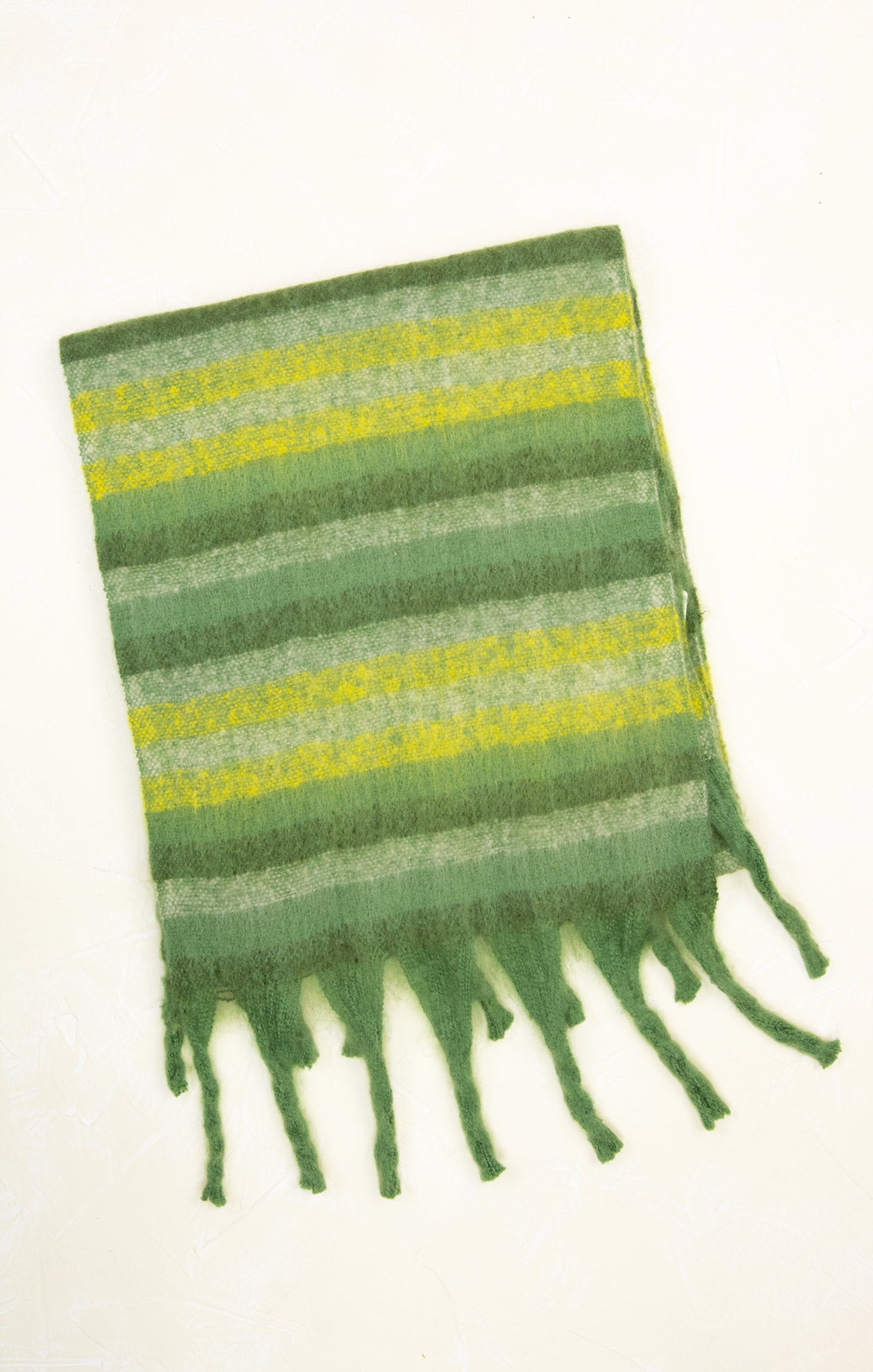 Green and yellow striped scarf with fringes on a white background