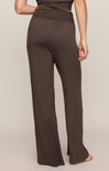 Brown wide-leg pants worn by a person on a beige background