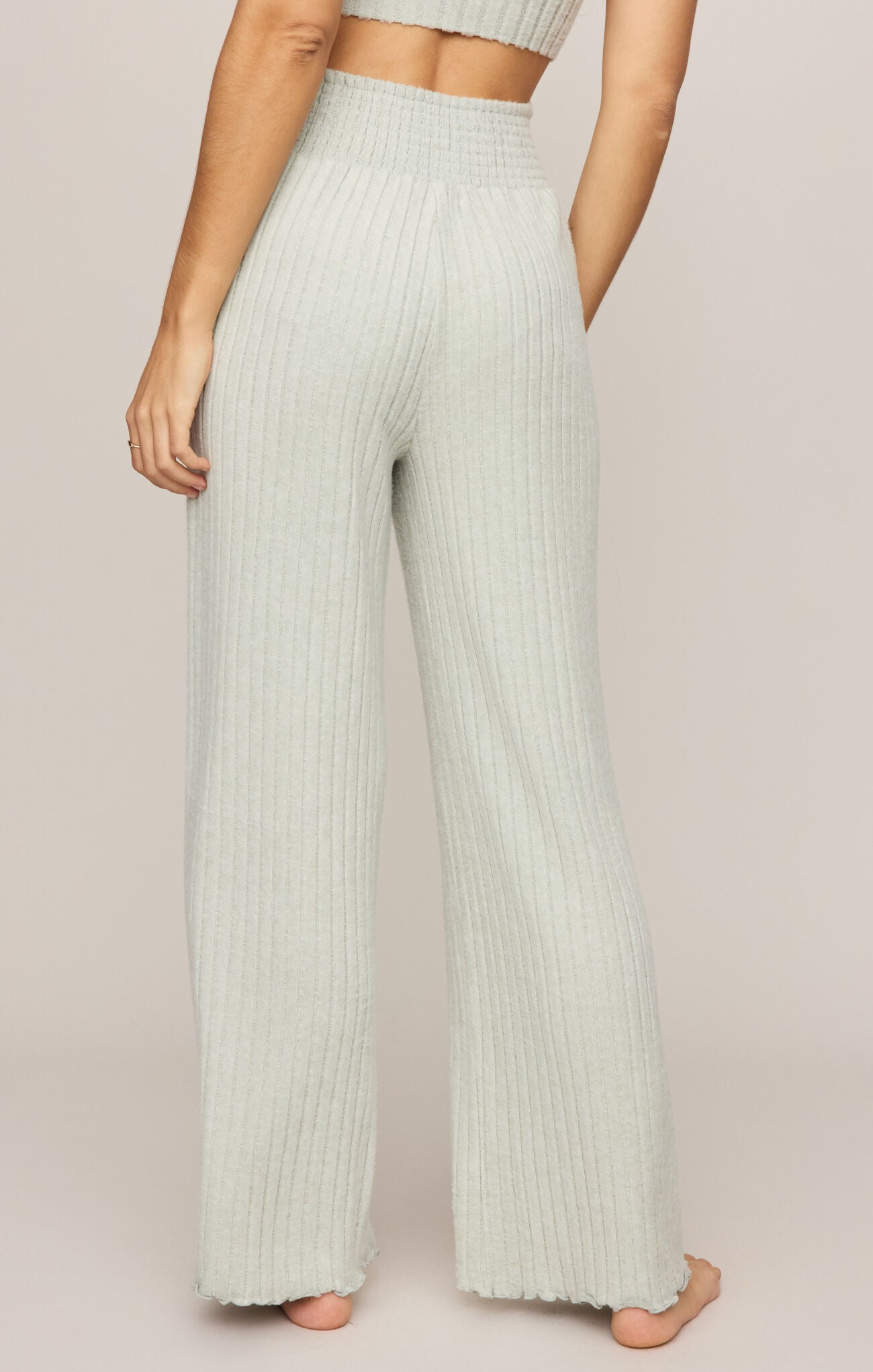 Light green ribbed pants worn by a person on a plain background