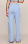 Light blue ribbed pants worn by a person on a beige background