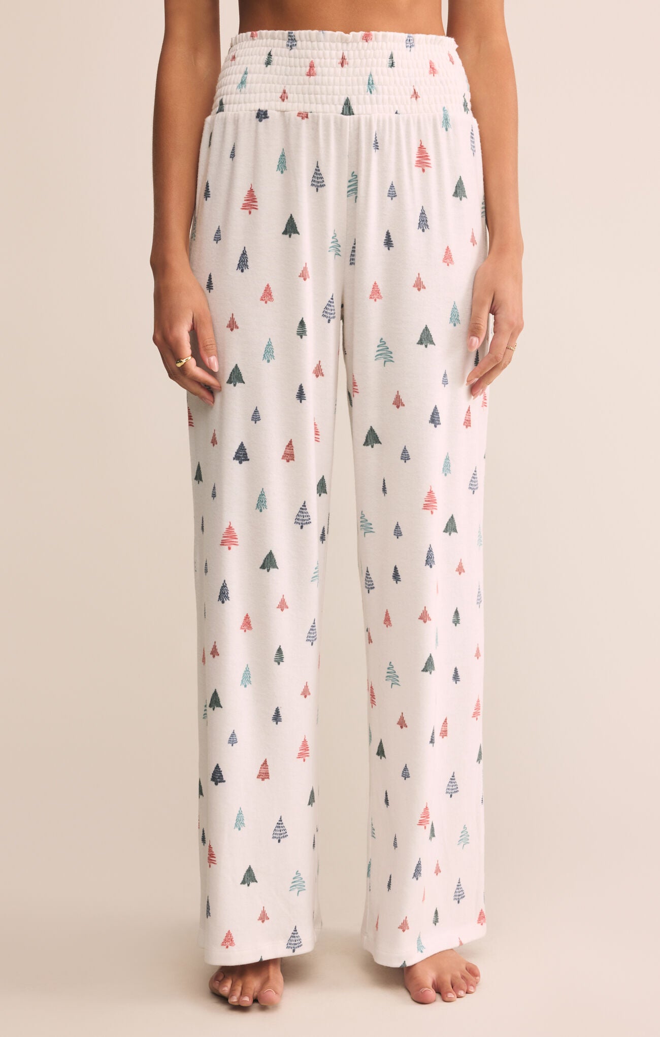 Patterned pajama pants worn by a person on a beige background