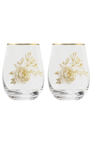 Two clear stemless wine glasses with gold floral designs on a white background