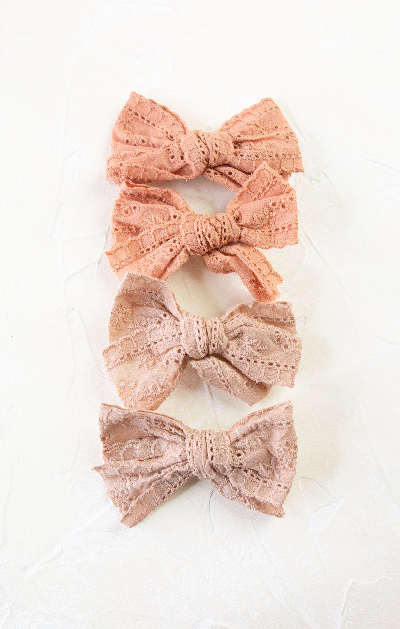 Set of three lace bow hair accessories on a white background