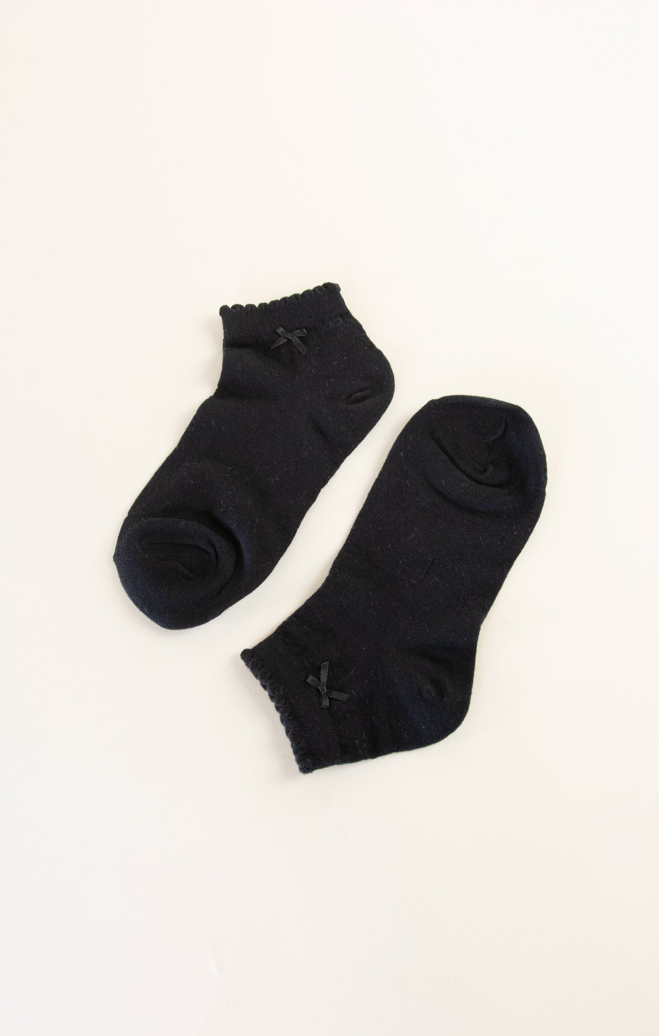 Pair of black ankle socks on a white background