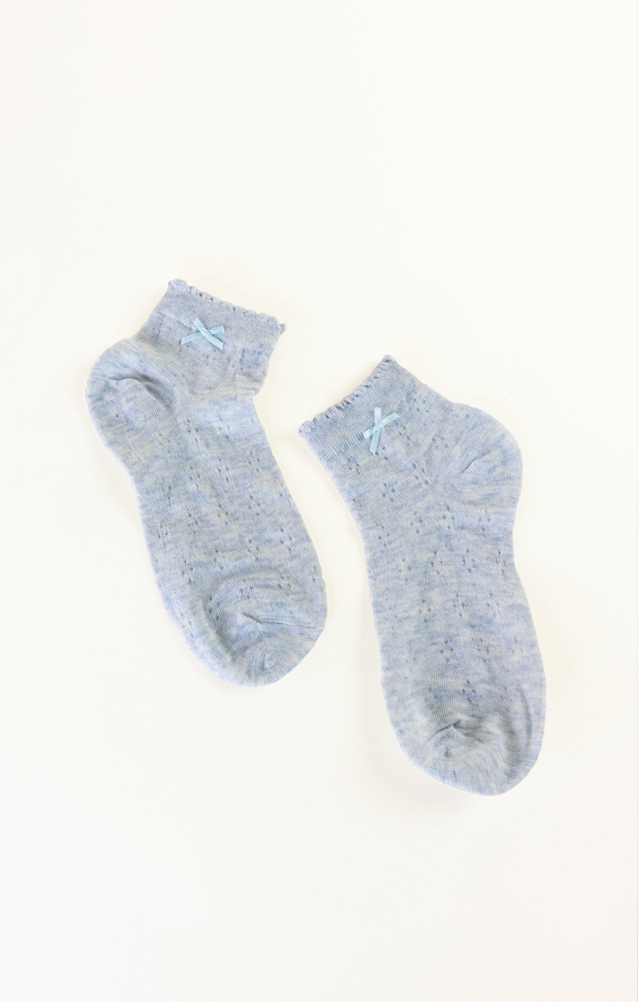 Pair of light blue socks on a white background