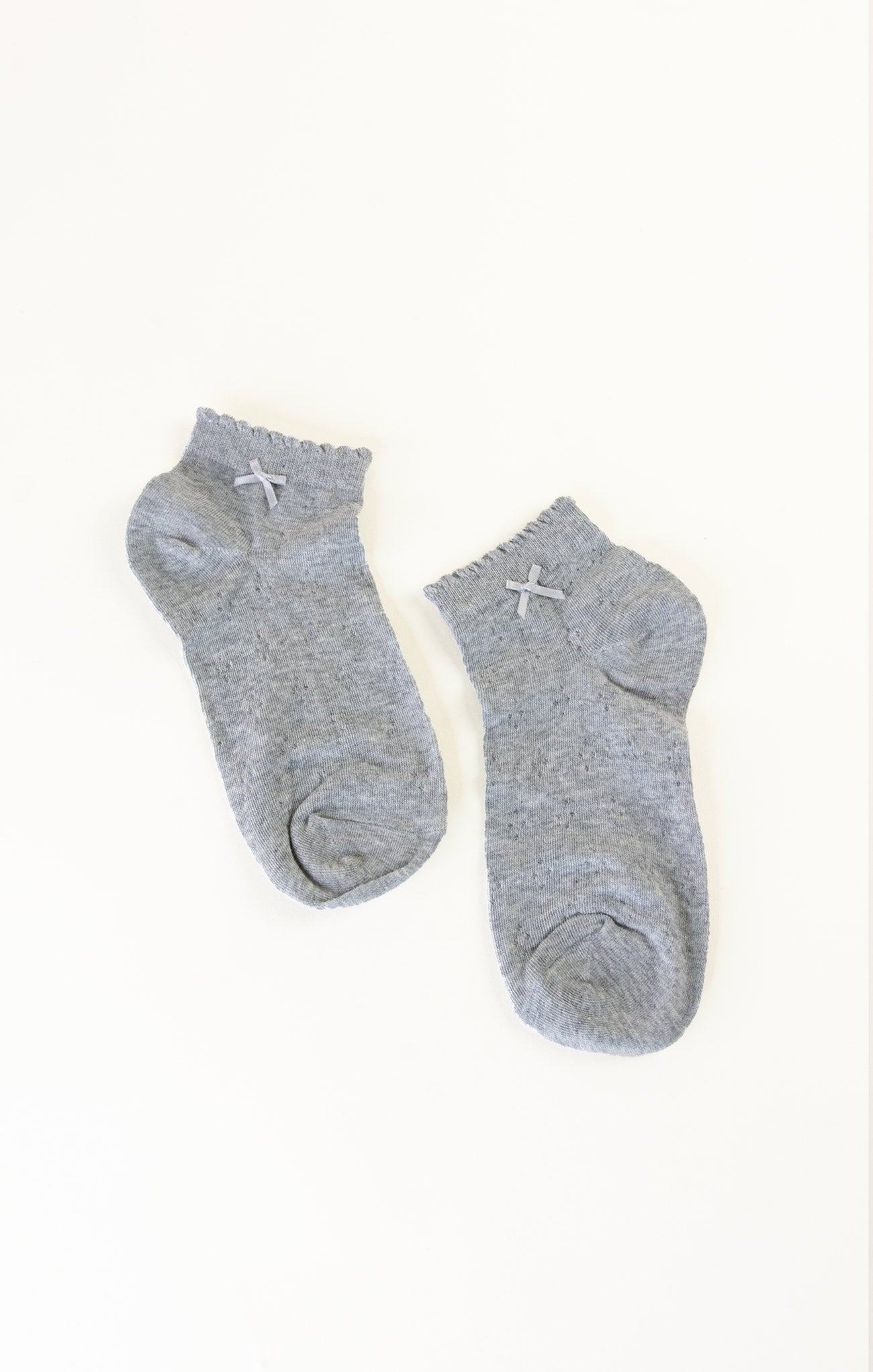 Two gray ankle socks on a white background