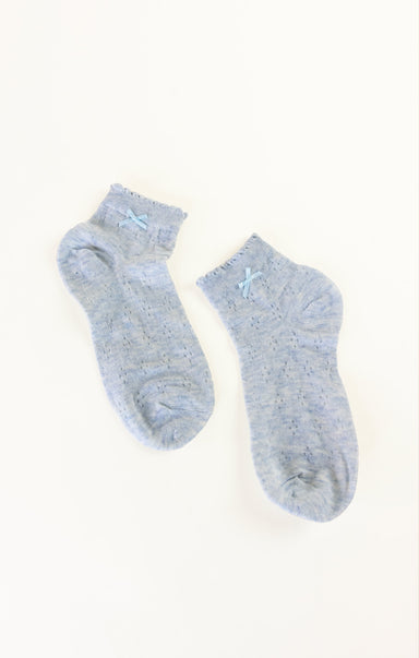 Pair of light blue socks on a white background