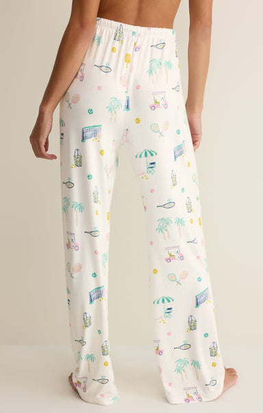 White pajama pants with colorful patterns on a neutral background