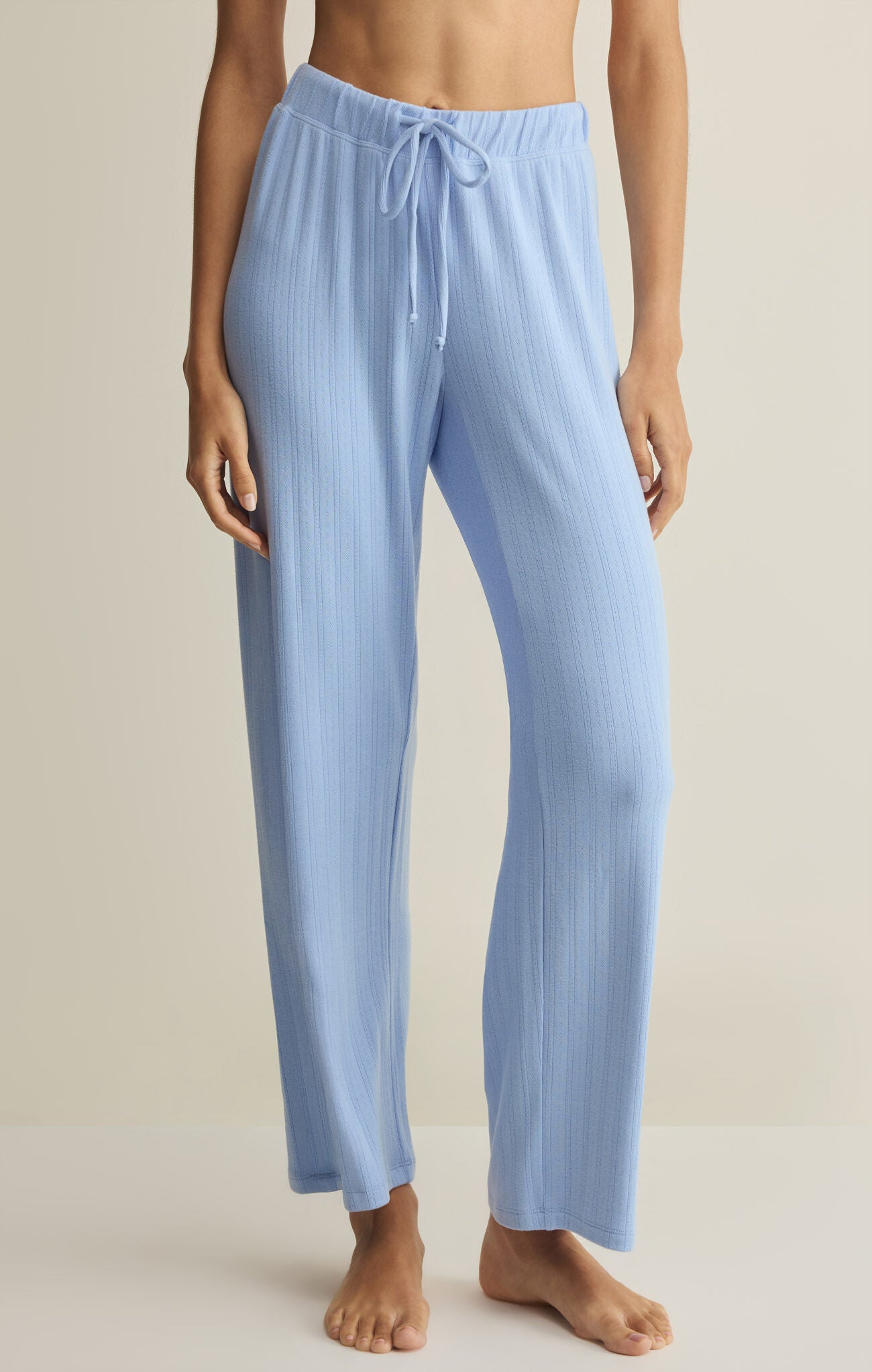 Light blue ribbed pajama pants worn by a person on a neutral background