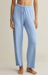 Light blue ribbed pajama pants worn by a person on a neutral background