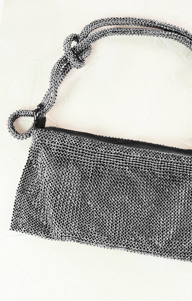 Close-up of a silver mesh handbag on a white background