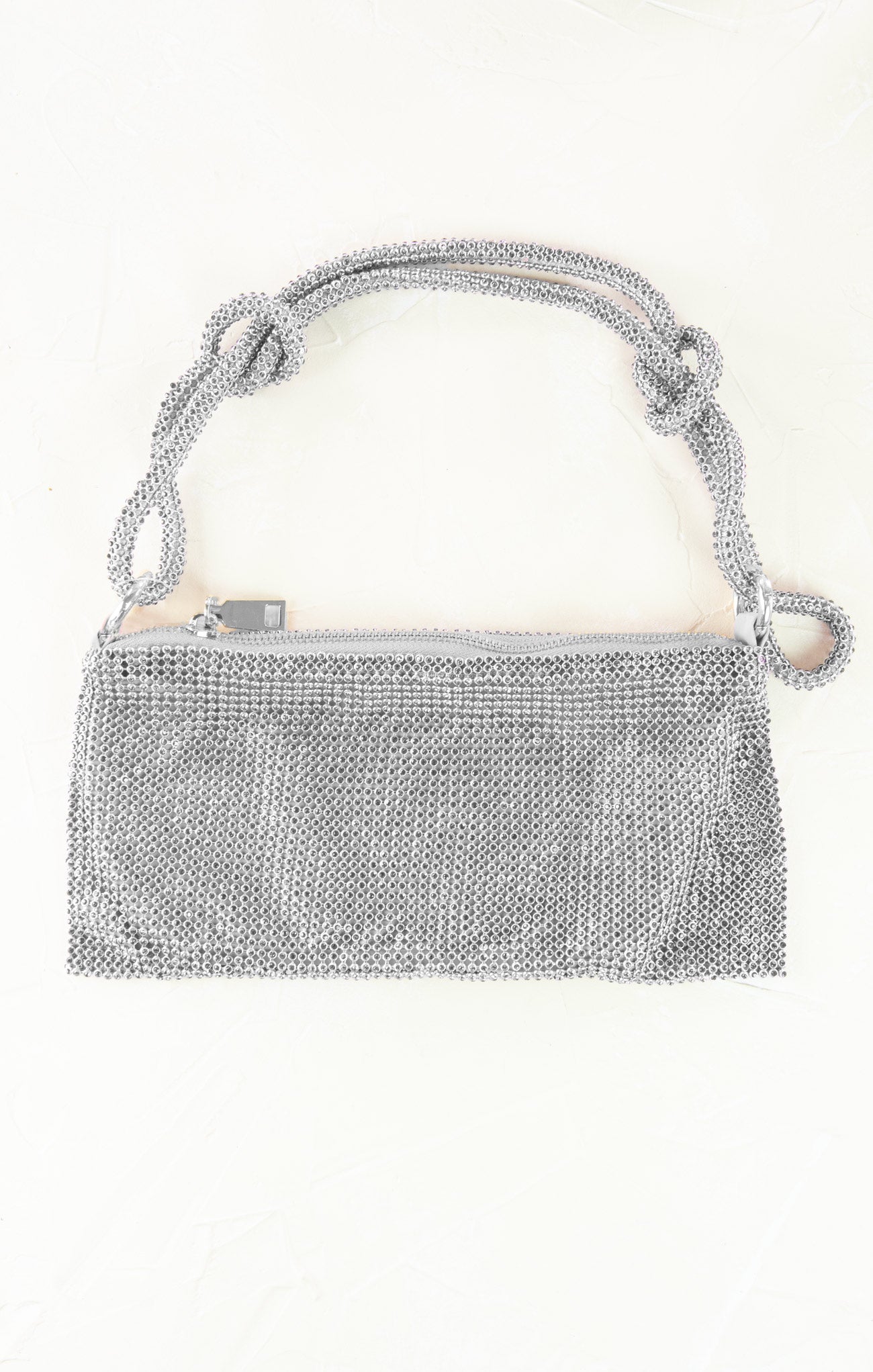 Silver mesh handbag with chain strap on a white background