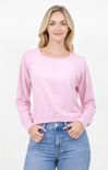 Woman wearing a pink sweater and blue jeans on a white background