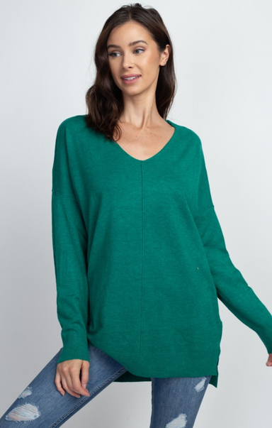 Woman wearing a green sweater against a white background