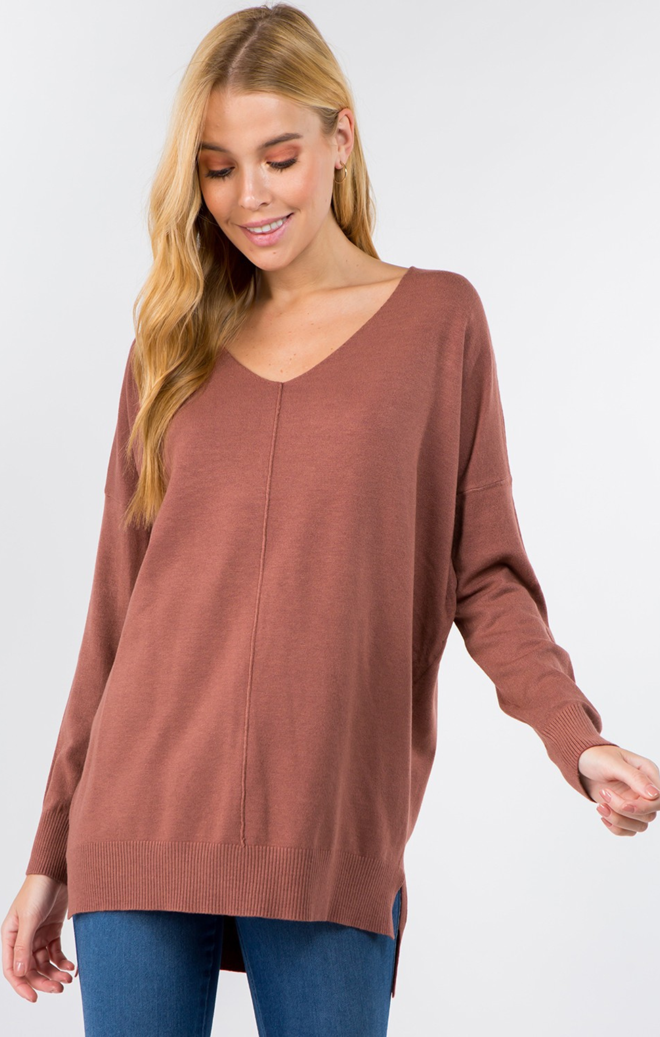 Woman wearing a brown sweater on a white background
