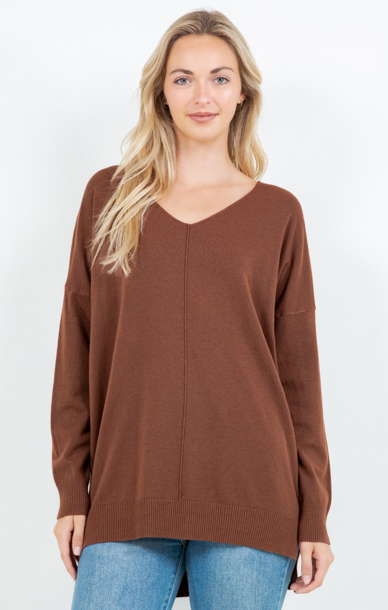 Woman wearing a brown sweater on a white background