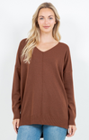 Woman wearing a brown sweater on a white background
