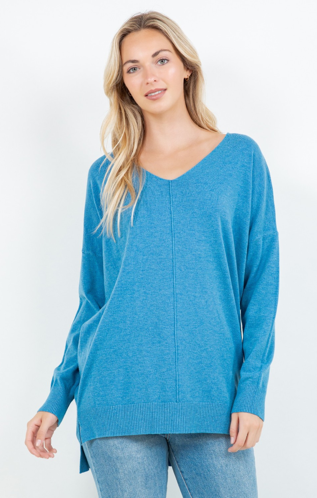 Woman wearing a blue sweater on a white background