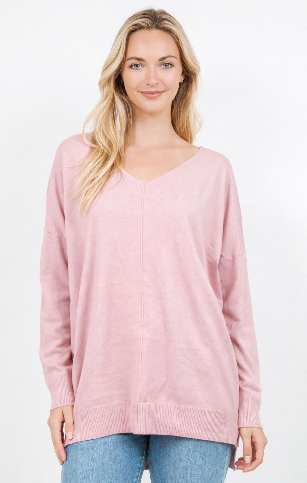 Woman wearing a pink sweater on a white background