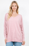 Woman wearing a pink sweater on a white background