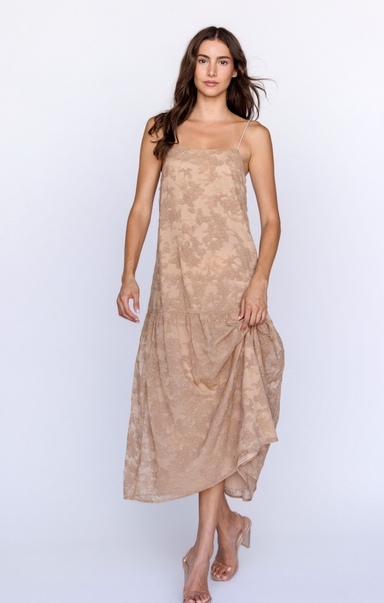 Woman wearing a beige strapless dress on a white background