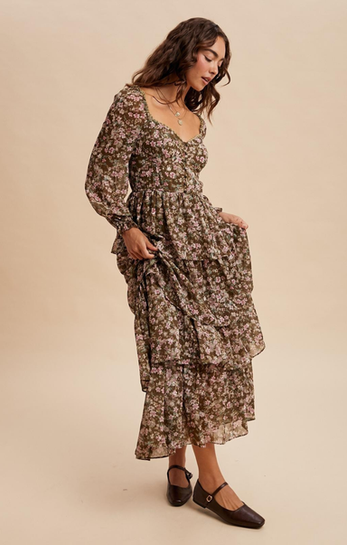 Woman wearing a floral dress against a beige background