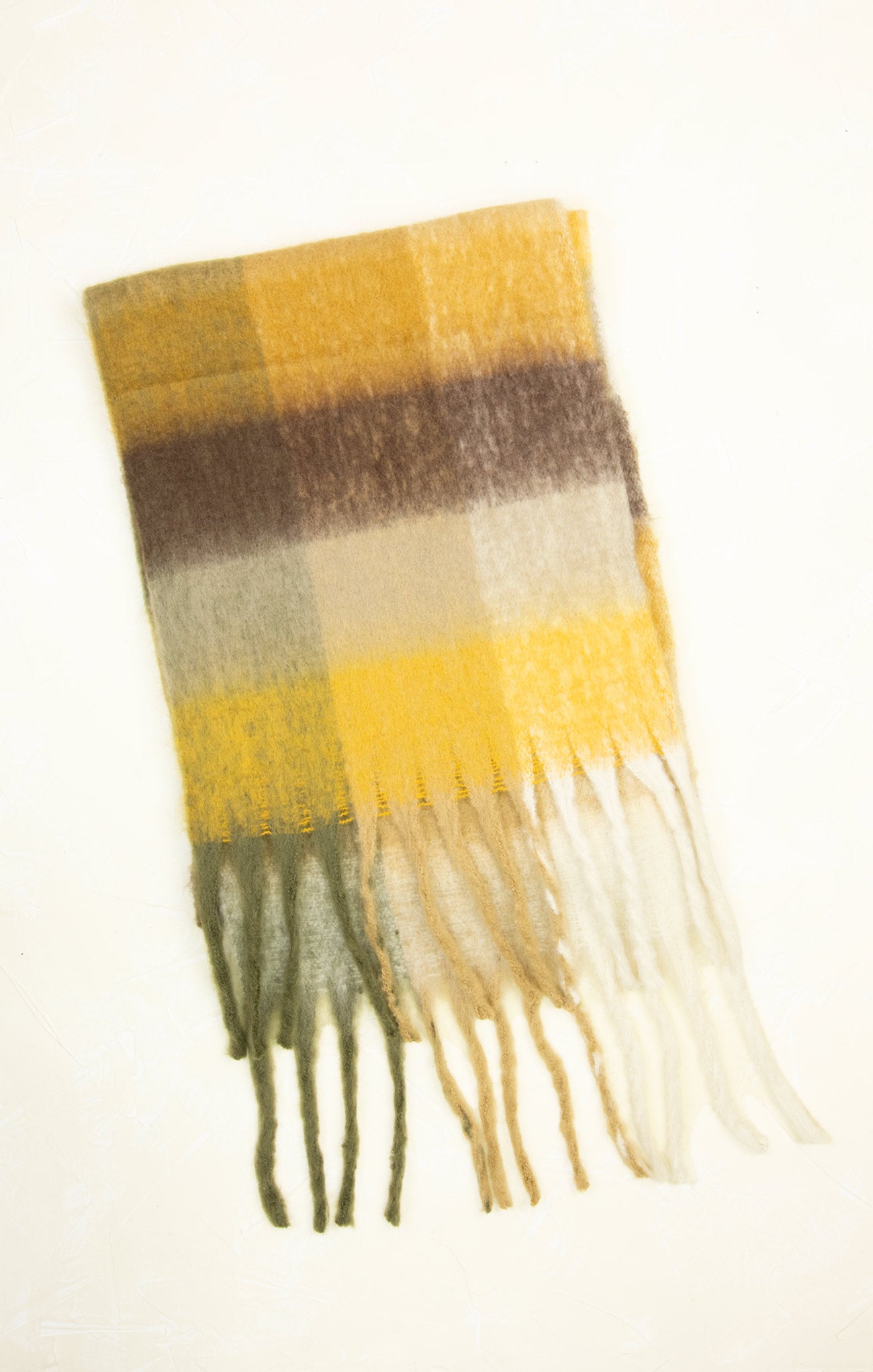 Plaid scarf with fringes in yellow, brown, and green on a white background
