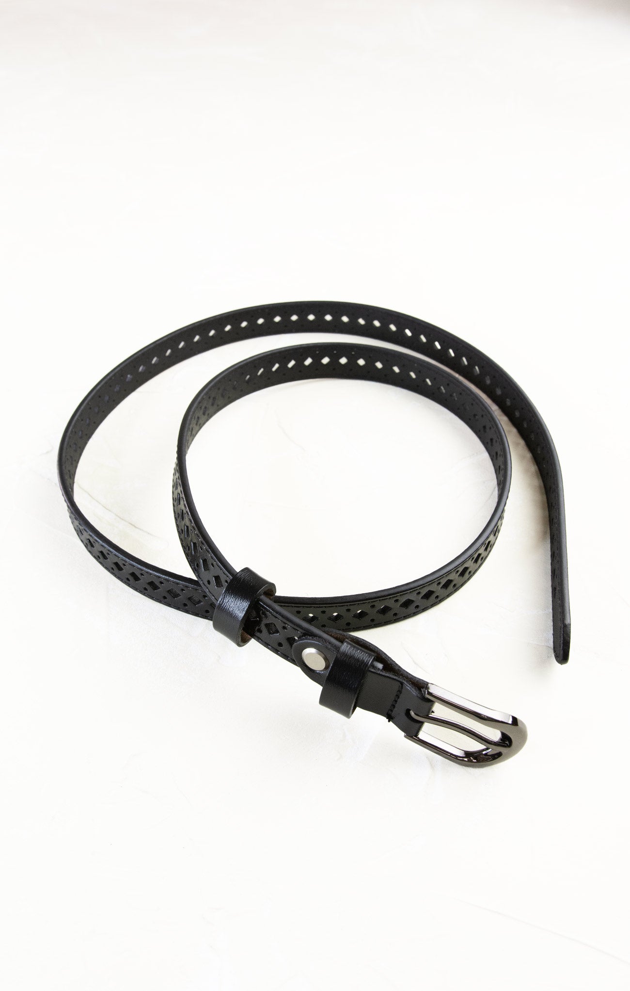 Black leather belt with perforated design on a white background